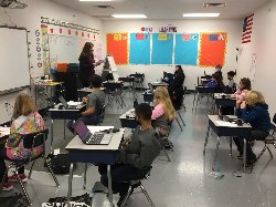 Picture of students and teacher in classroom.